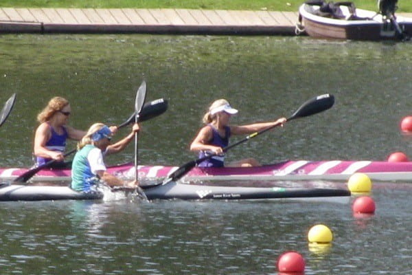 Cindy Deugo Johnson races at the Masters Canadian Championship in 2015 with Olympian Sue Holloway. They are crossing the finish line first, winning the Masters Women K-2.