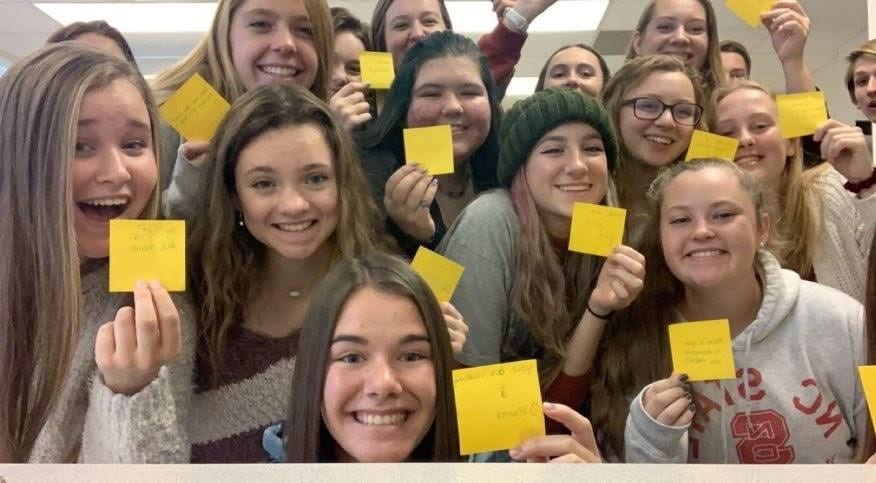 PEER writes positive messages to put on every desk in the school for Kindness Day in November before the pandemic. PEER is a student group whose main goal is making the school a positive and inclusive community for everyone. 