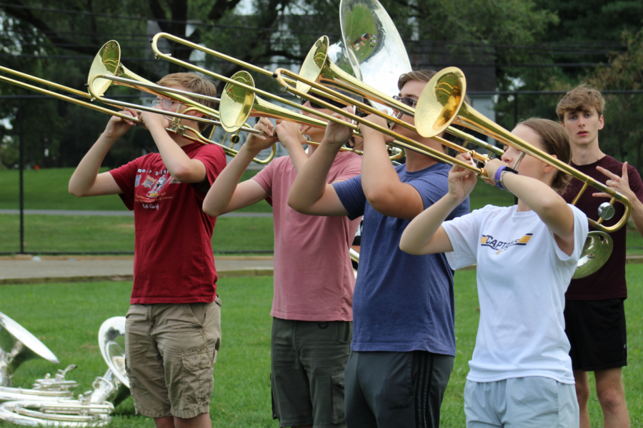 The trombones section warms up in playing position during an after school practice. The marching band practices after school in preparation for performances such as the halftime performance at the JV and Varsity football games. 