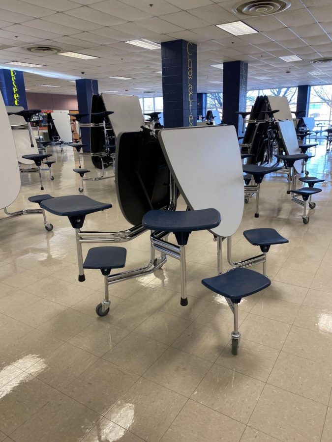 New round tables are folded up to begin cleaning at the end of the day. These tables make it much easier for the custodians to get around and mop as well as clean surfaces. 