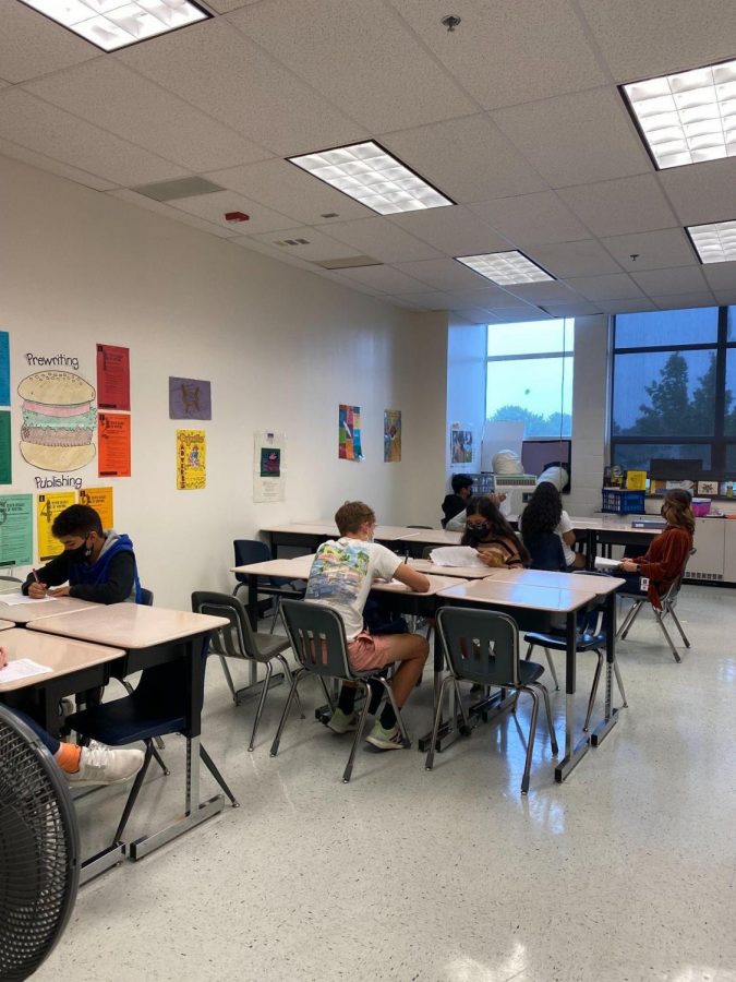Students work hard on a packet in Jessica Goddard’s Academic World History class.They make the most of the limited space they have to complete their work. 
