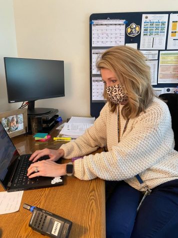 Inman sits in her office sending various emails and typing away. She works hard to finish the many different tasks she faces throughout the day.