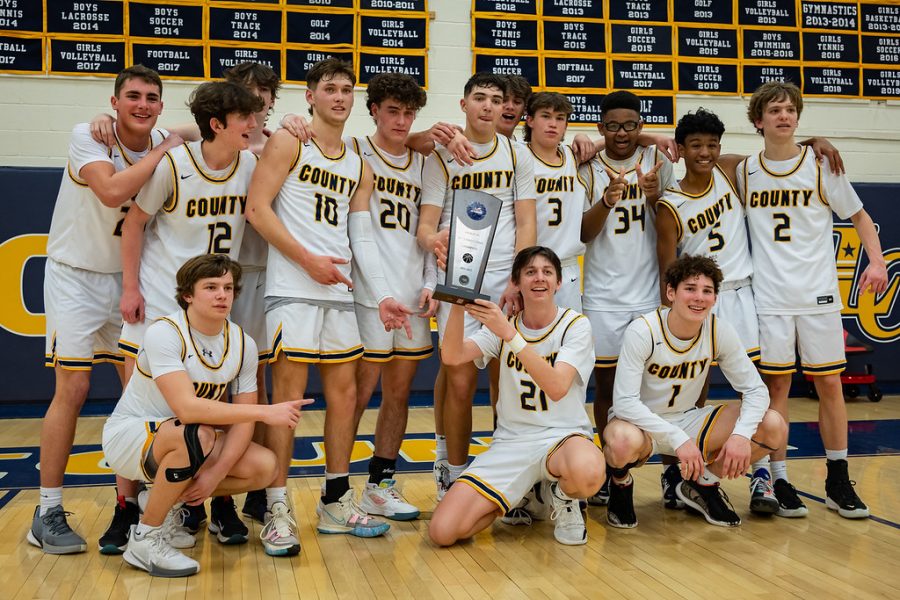 Members+of+the+boys+basketball+team+pose+after+winning+the+regional+championship+against+Loudoun+Valley+on+February+25.+The+game+was+close%2C+but+the+Captains+pulled+a+61-57+win+over+Valley+to+continue+their+journey+to+the+state+championship+versus+the+Varina+Blue+Devils.+Photo+by+Jim+Klimavicz.+