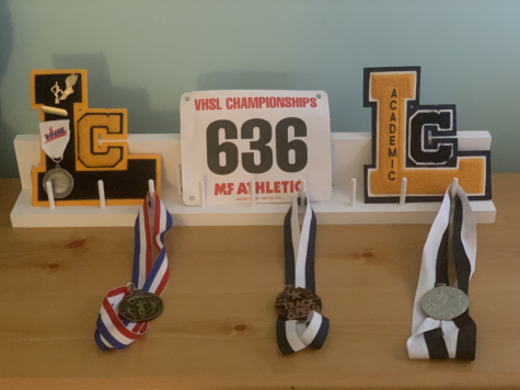 I display my XC and Track varsity letter and awards, along with my academic varsity letter on a medal stand. It made me wonder what other students do with their letters. Photo by Cat Pizzarello.