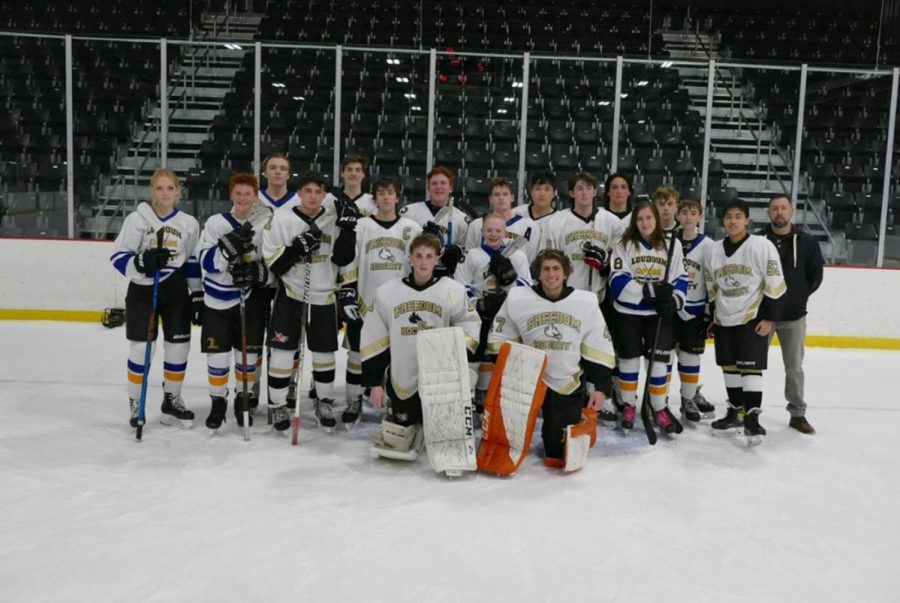 The Freedom/County team stands with big smiles after a win. Freedom High School partners with County in order to roster a team large enough to compete in the Northern Virginia School Hockey League.