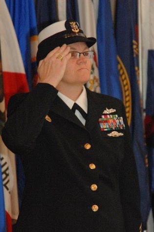 Foust saluting at her Navy Retirement ceremony in December  2010 after 28 years of serving in the Navy. Shortly after her retirement, Foust started her job with the Loudoun County NJROTC. 