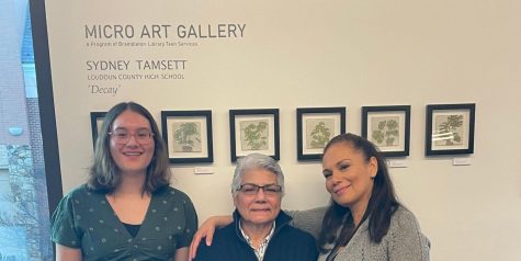Senior Sydney Tamsett (left) with her great aunt, Ada Patroni, and mother, Anasofia Monteblanco, at the exhibition of Tamsett’s work “Decay” on display at the Brambleton Library. Tamsett created the six watercolor panels over the course of a few weeks in her Art III class. Photo courtesy of Sydney Tamsett.
