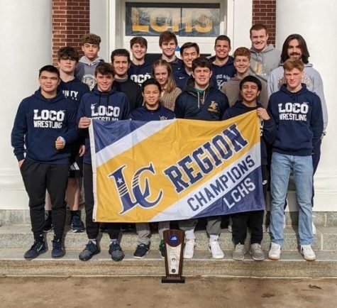 The wrestling team holds up the region flag after winning their second region title in three years on February 11. Left to right: (Back row) Lincoln Kelley, Darrin Sever, Brandon Ahearn, Troy Chung, Octavian Ashford, Andrew Bedrousky. (Second row) Joshua Buchanan, Jayden Pearson, Grace Roberts, Eli Eastlake, Jackson Snyder. (Front row) Justin Lowry, Carson Kelley, Bryson Rios, Drew Eastlake, Alexis Cuatlacuatl, Josiah Smith. Photo by Mike Petrella.