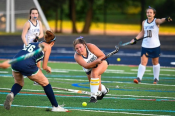 Emma Janusko (left), Lindsey Johansen (middle) and Jane Garvey (right), engage in field hockey gameplay against Woodgrove. Johansen is a captain on the field hockey team, leading her team to a successful season.