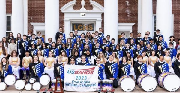 The Marching Band gathered up in front of the school, smiling proudly after winning first place at the USBands National Championships at the Metlife Stadium in East Rutherford, New Jersey where they competed against 19 other bands.