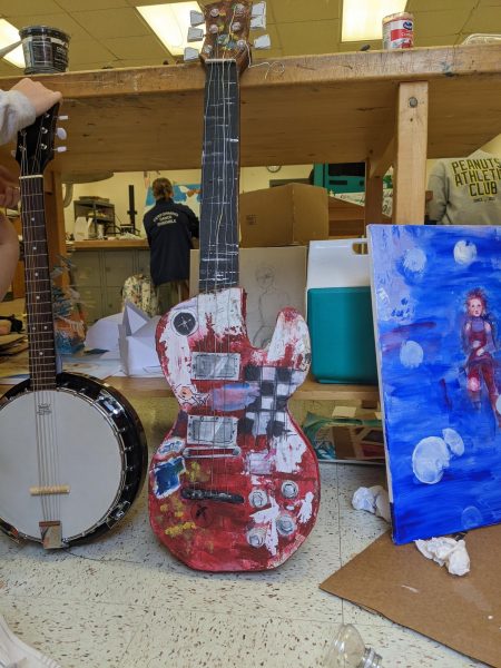 At a summer art program, junior Gloria Wu created a piece inspired by a character’s guitar in the recent release “Spiderman: Across the Spider-Verse.” Although Wu’s preferred medium is acrylic paint, she explored new techniques and used cardboard and Styrofoam to construct the guitar. Photo by Gloria Wu.