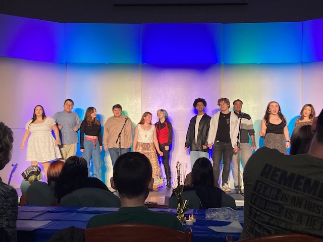 Members of the choir program join together for a final encore after a night of duets and solos. Here they sing “Aquarius/Let the Sunshine In” from Hair while the audience listens. From left to right: sophomore Rae Creppon, freshman Justin Goodhart, sophomore Norah Lee, junior Sam Takemoto, senior Grayson Weber, senior Cy Starr, senior Jayden Reynoso, sophomore Collin Diem, senior Kevin Jennings, freshman Emma Nicholson, and senior Vanessa Carranza. 