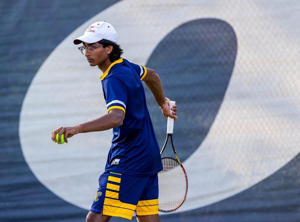 Team captain Jinu Manalel prepares to serve at a home match. Mandel is on the tennis team alongside Tyler Partlow, Tyler Colavita and Aidan Armistead, who have all contributed to the team’s strong record.