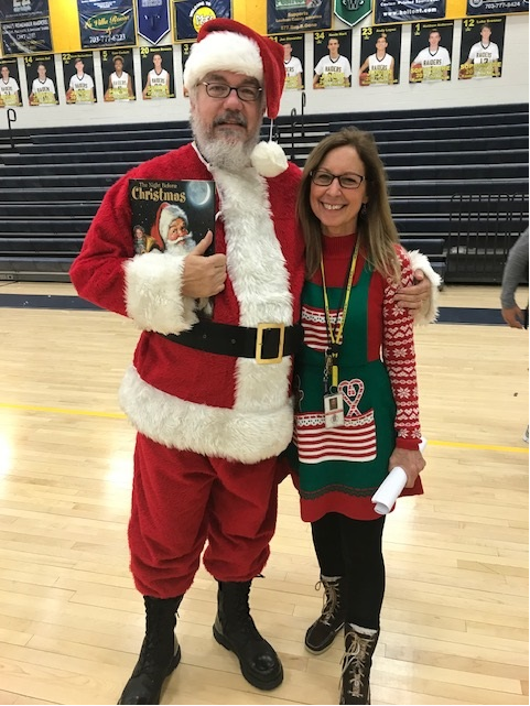 Mark Patterson with “helper” Nancy Thomas during a winter sports pep rally. Patterson has dressed up as Santa multiple times for this event.
