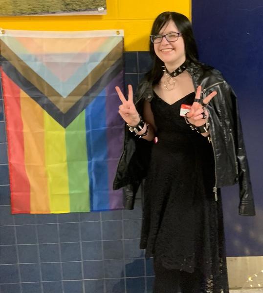 Senior and GSA member Sydney Bourgeois stands next to the Pride Progress Flag. The Pride Prom took place on May 4 and was a place for those attending to be themselves around those in similar circumstances. 