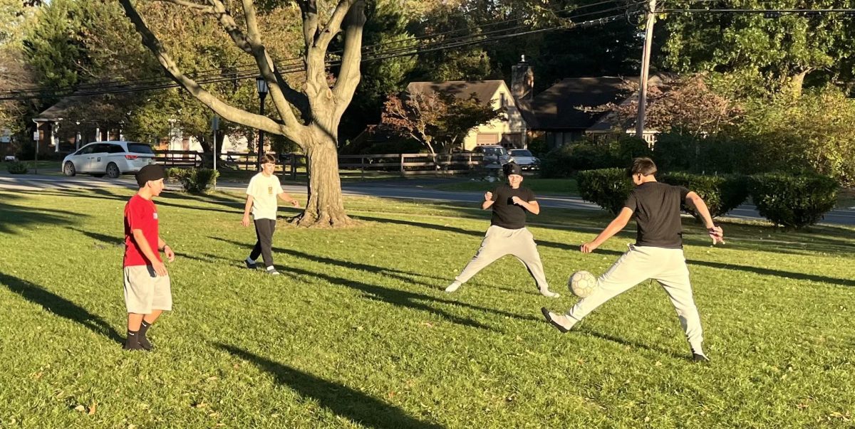 Students play soccer during the tailgate event. The event also offered  soccer and spikeball. Photo by Dylan Johnson.