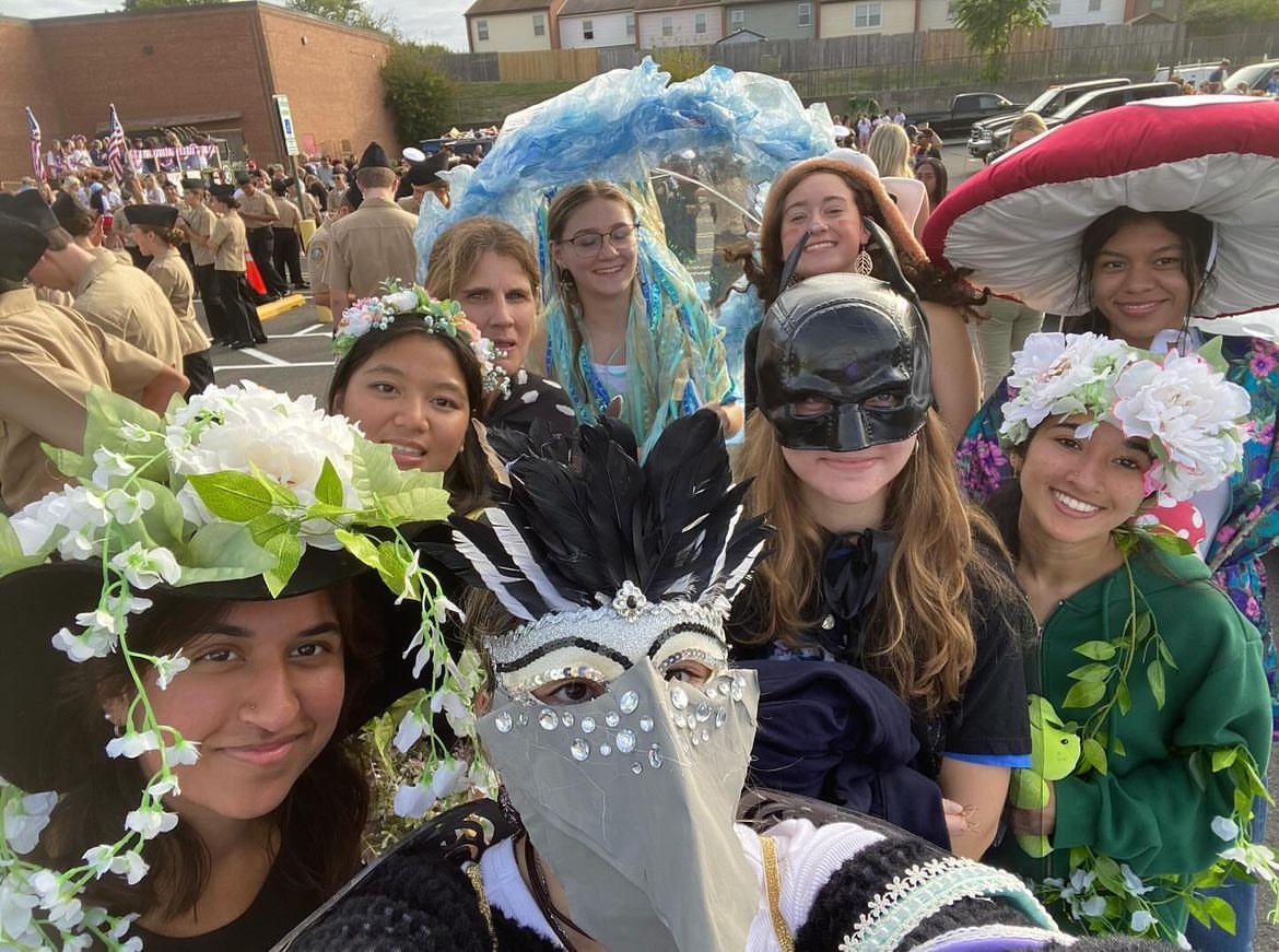 (From left to right) Junior Nur Mustafa, senior Beaunita Nith, club sponsor Tracy Webster, junior Elizabeth Geidl, freshman Alexia Boyer, junior Eva Moore, junior Kathia Gaitan-Montoya, junior Ima Mazhar and junior Karen Jimenez dress up in recycled materials to show their goal of sustainability at the Homecoming parade on September 19. Environmental club prides itself on focusing on volunteerism to reach their goal of making sustainability the standard.