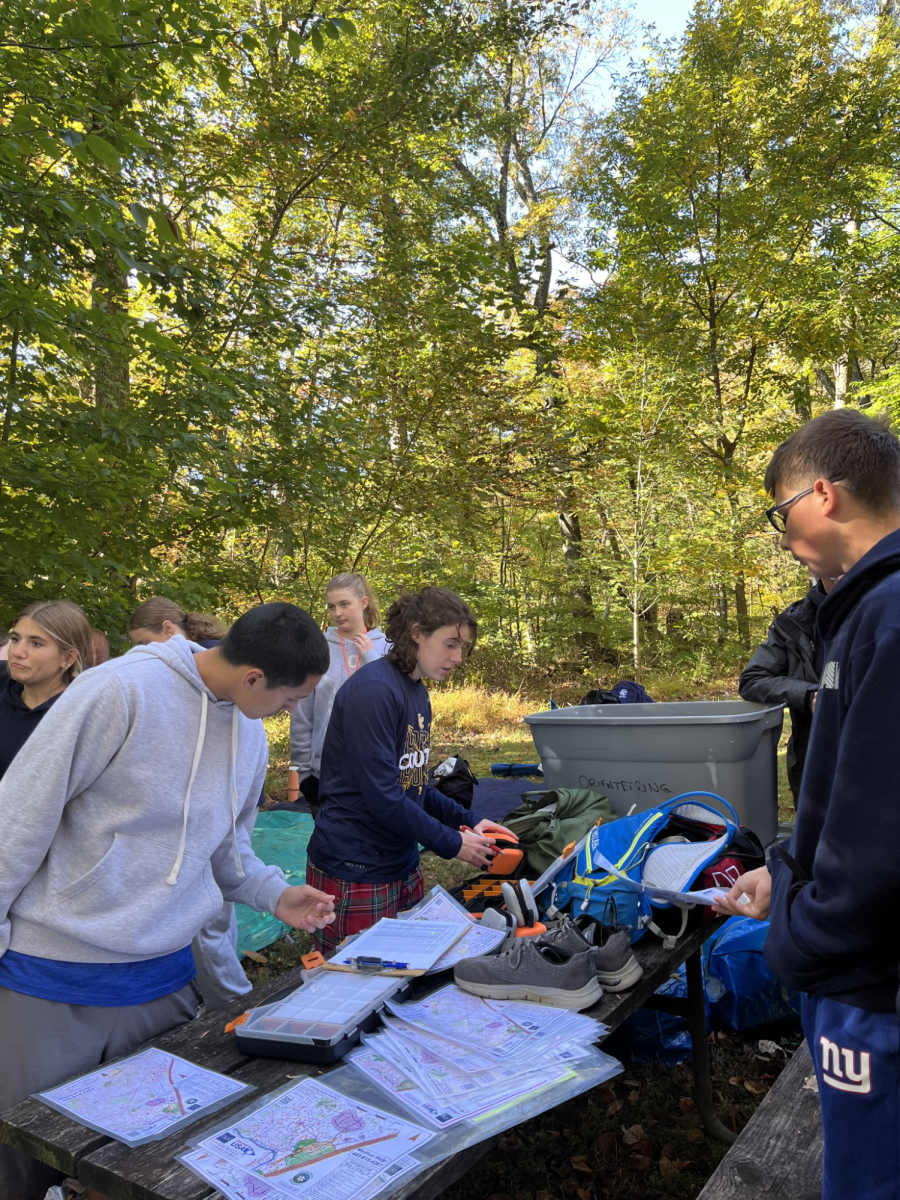 Junior Fallon Murphy hands out compasses to cadets at the Cunningham Falls Orienteering meet on October 20, 2024. This year, Murphy will serve as the first female team captain for the NJROTC Orienteering program.