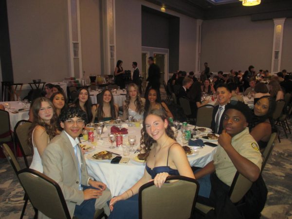 Pictured: Sophomores Medina Canic, Eva Rodriguez, Bailey Welch, Lily Gingerich, Nava Gessesse, Iverson Paredes, Mariana Martin, Sierra Shaffer, Justin Goodheart, Felix Dema-Nahr, and junior Aaliyah Trammel. Each year at the Military ball, NJROTC cadets are allowed to bring along two guests to join them for the night. Additionally, they can also put in requests for seating arrangements, picking who will be seated with them at their table. “I decided to sit with my table because we all sat together at the Ball during our freshman year,” Canic said. “We wanted to keep the tradition alive.” Canic also recalled her favorite memory from the night, stating that “dancing at the end” was the most memorable. Photo by Sabrina Simpkins (@sabrina.photographs).