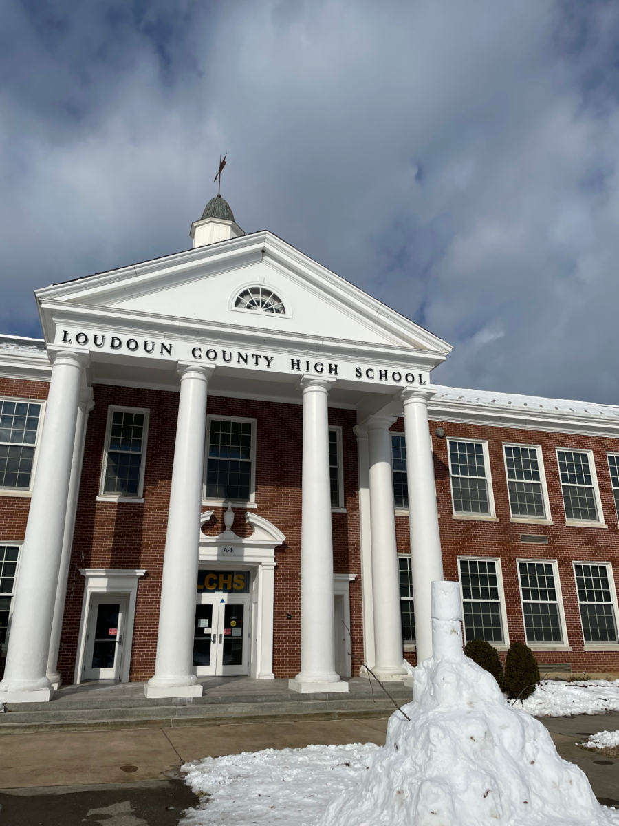 A snowman created by local residents decorates the front lawn of the snow-covered building on Wednesday, January 8, the third day the county had off. A storm coming through on the last day of winter break extended the break by adding four consecutive snow days. 