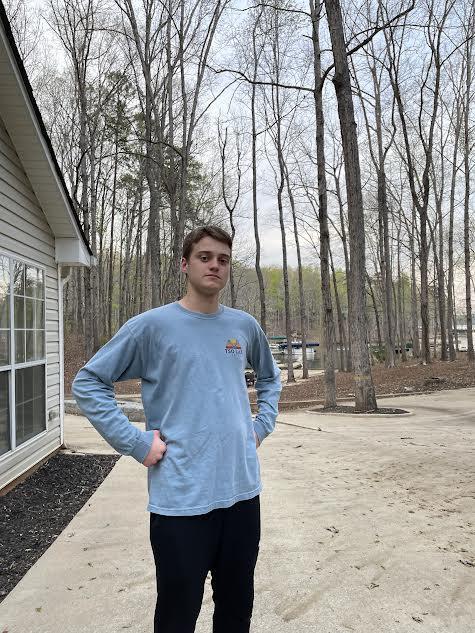 Senior Andrew Wilson poses in front of one of the courses cadets will have to traverse in orienteering competitions. Wilson is one of several leaders on the NJROTC orienteering team.