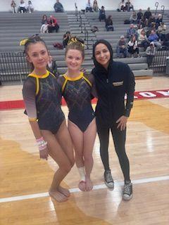 Valerie Lindquist, Ellie O’Brien, and Hidayyah Ishaq pose together after their meet at Heritage on December 11, 2024. Lindquist placed 3rd on vault and Ellie improved on her vault.