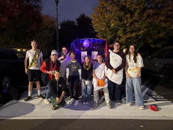 (Left to Right) Junior Nathaniel White, retired Latin teacher Lynn Krepich, senior Caroline VanEpps, freshman Linden Rosati, senior Pierson Lee, junior Emma Hawkins, junior Nik Scuric, junior Mark Giardina, and junior Taylor Helfer stand in front of the Latin club car at the Trunk or Treat event on October 29. Under the sponsorship of Spanish teacher Matthew Landers, the Latin club has been able to keep the Roman culture alive through arts and crafts, events, such as Trunk or Treat, and mythology.