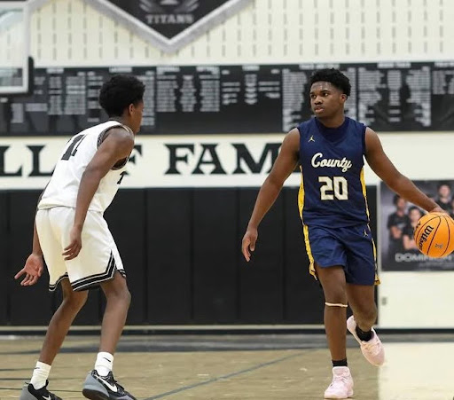 Senior Christian Dema-Narch dribbles around a defender during their game against Dominion on January 22. The Captains lost 60-81 to Dominion. Photo courtesy of @dmv.flickz