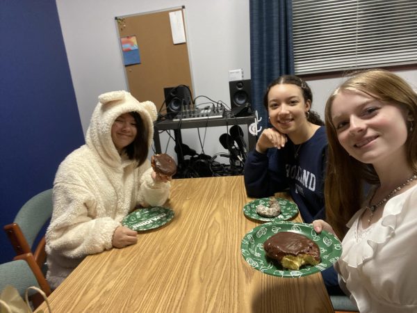 Seniors Chloe Ortiz, Brooke Young, and Kai Rothwell stop for a break during their time volunteering at our school library. The students help to organize books, including retrieving and sorting the study hall reading crates, which need to be stored during the summer HVAC work.  