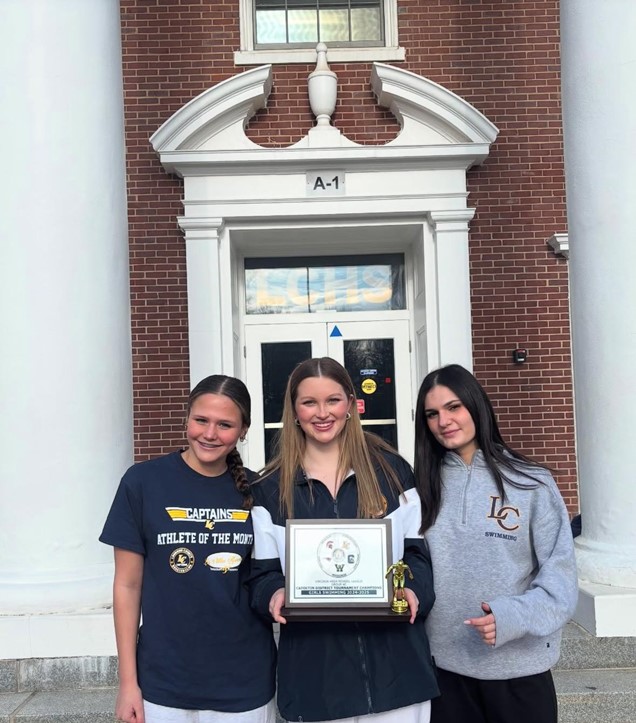 Juniors Ellie Smith, Emerson Gatlin, and Anna Giudice stand together holding the district championship trophy. Smith, Gatlin, and Giudice are a part of the swim team, who have broken multiple school records this year. Photo courtesy of @emerson.gatlin on Instagram