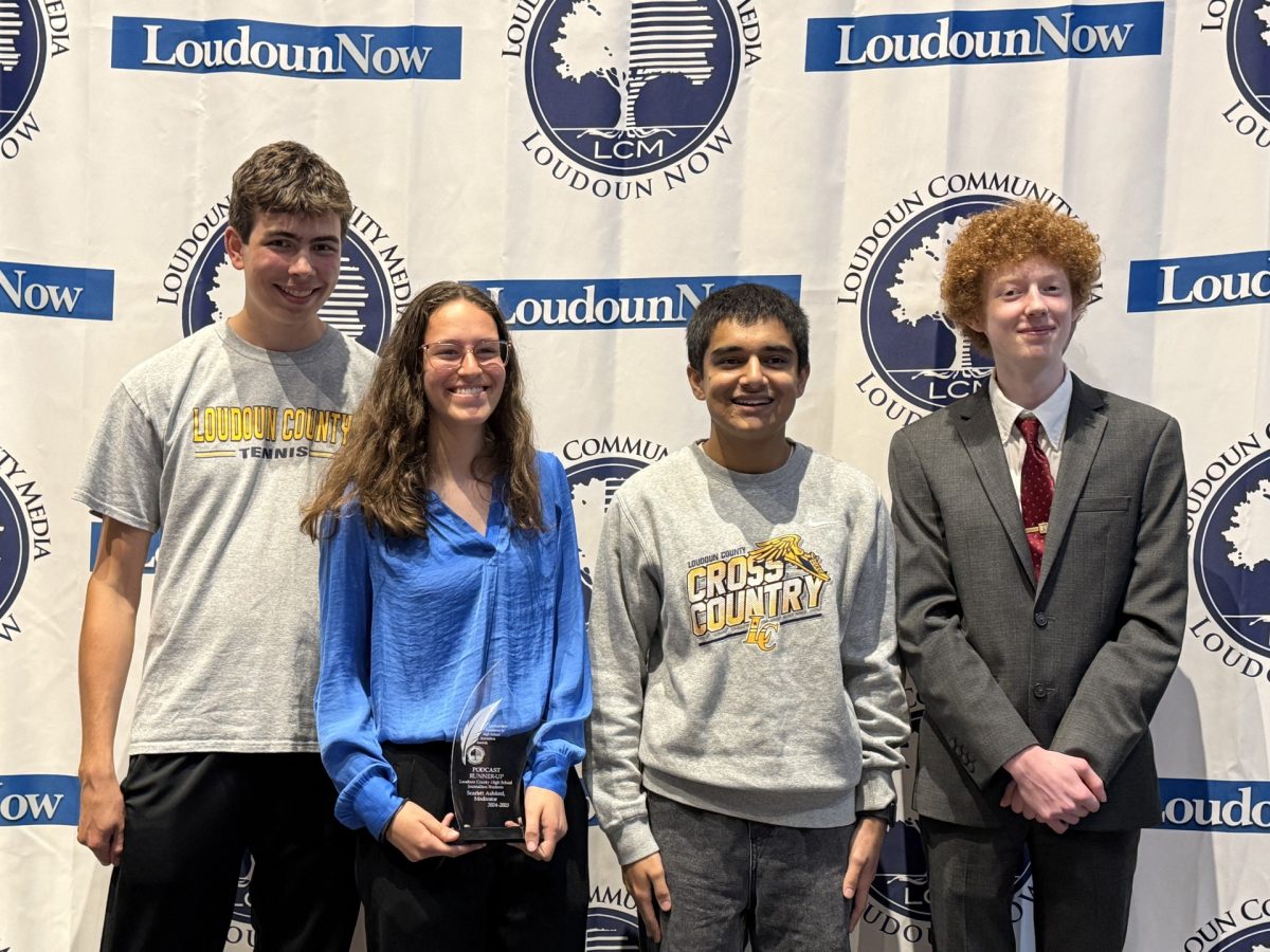 The County Chronicle nominees senior William Kluttz, sophomore Scarlett Ashford, junior Karan Singh and
senior Berek Harrison pose during the first annual Loudoun Now Excellence in Journalism awards night,
held at Loudoun County High School. Ashford’s podcast, during which she interviewed former superintendent Edgar Hatrick, won runner up in the podcast category. “I had little expectation going into the evening
about how it would go since this is the first year that Loudoun Community Media was offering the awards,”
librarian Patti Bagdasarian said. “I was impressed by the entire program, from the reception beforehand, to
the emcee (News 4 Bureau Chief!), to the high level and involvement of the sponsors, but most importantly,
how they created this program to honor the commitment, hard work, and excellence of our student journalist. It wasn’t lost on me that Scarlett won for an interview of Dr. Hatrick in the building where he started and
spent much of his career.” Bagdasarian not only attended the event, but helped Ashford produce her podcast
with the library’s recording equipment. 