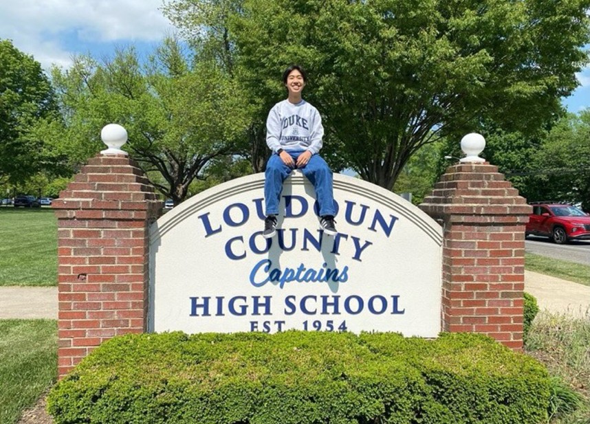 Pierson Lee sits on top of the school sign for a picture announcing him as commencement speaker for social media. Lee plans to study biophysics at Duke University in the fall. Photo courtesy of @lchs1954
