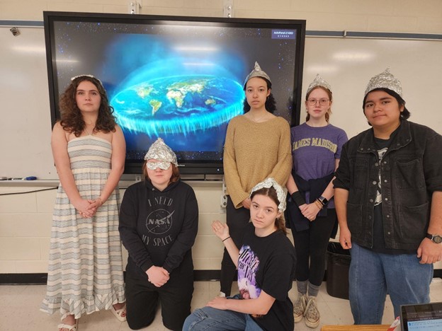 Members of the Space Club put on a special presentation for all the science classes during the first week of April, demonstrating that the Earth is clearly flat. Afterwards, the club sold tin foil hats as a fundraiser to purchase new science textbooks for the school. Photo by tin foil hat-wearing astronaut.