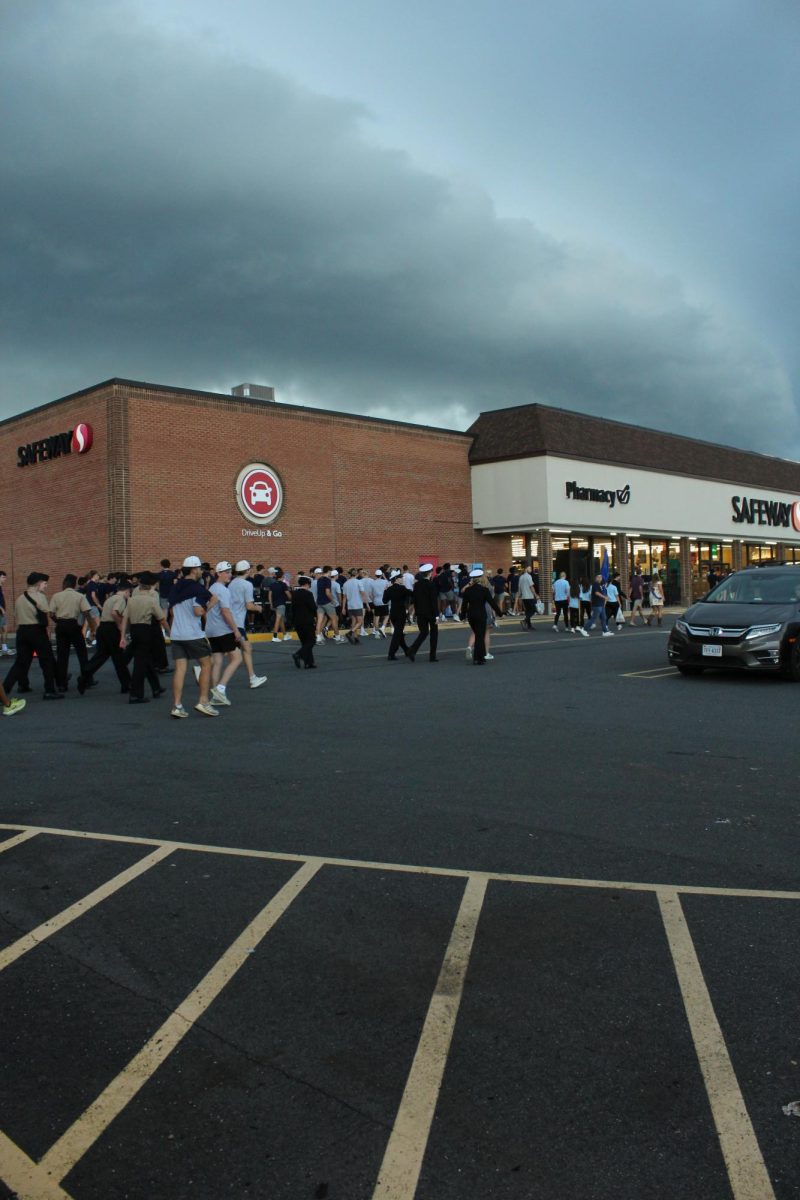 Students, including Naval Junior Reserve Officers Training Corps (NJROTC) cadets, various clubs such as Future Business Leaders of America (FBLA), or Environmental Club rush into Safeway as ominous clouds hover above them. Right before the parade was set to commence, the parade was put on pause due to a tornado warning, forcing student organizations to gather their instruments, NJROTC exhibition guns, and other hand-made signs to avoid the weather. After heavy rain, lightning, and strong winds, the parade commenced. 