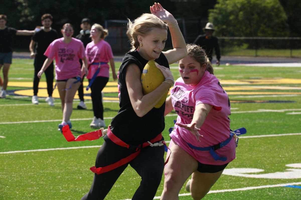 Senior Olivia Janusko (right) reaches for junior Kate Garren’s (left) flag in an attempt to prevent the junior team from scoring a touchdown. 