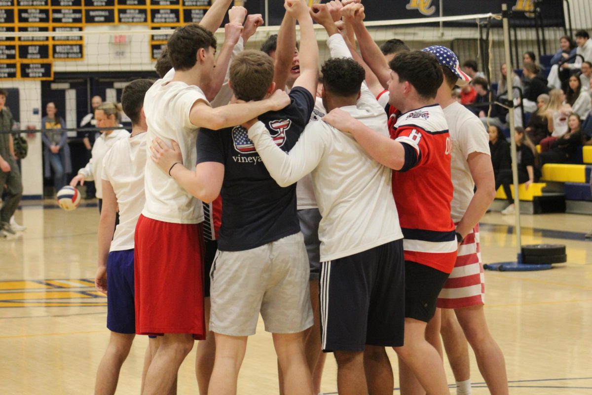 After their entrance to the YMCA, senior boys hype each other up before their first game against the sophomore boys while dressed in red, white, and blue.
