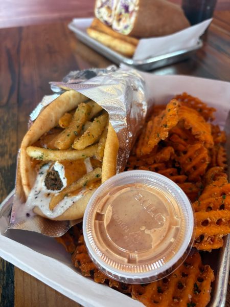 The “SPITZ gyro,” featuring a zesty feta spread, berliner sauce, falafel, and pita, with a side of sweet potato fries. SPITZ is one of many places which engage in environmentally-friendly practices.