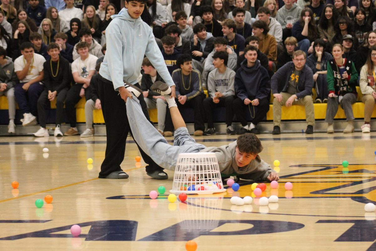 Freshman Shayaan Ashraf drags Freshman Nathan Fish, who is on a scooter, acting as the legs of their “hippo.” In an attempt to win the game, the duo uses their basket to grab the most amount of balls. 